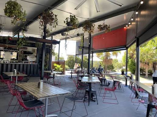 Tables in the open air beside the park