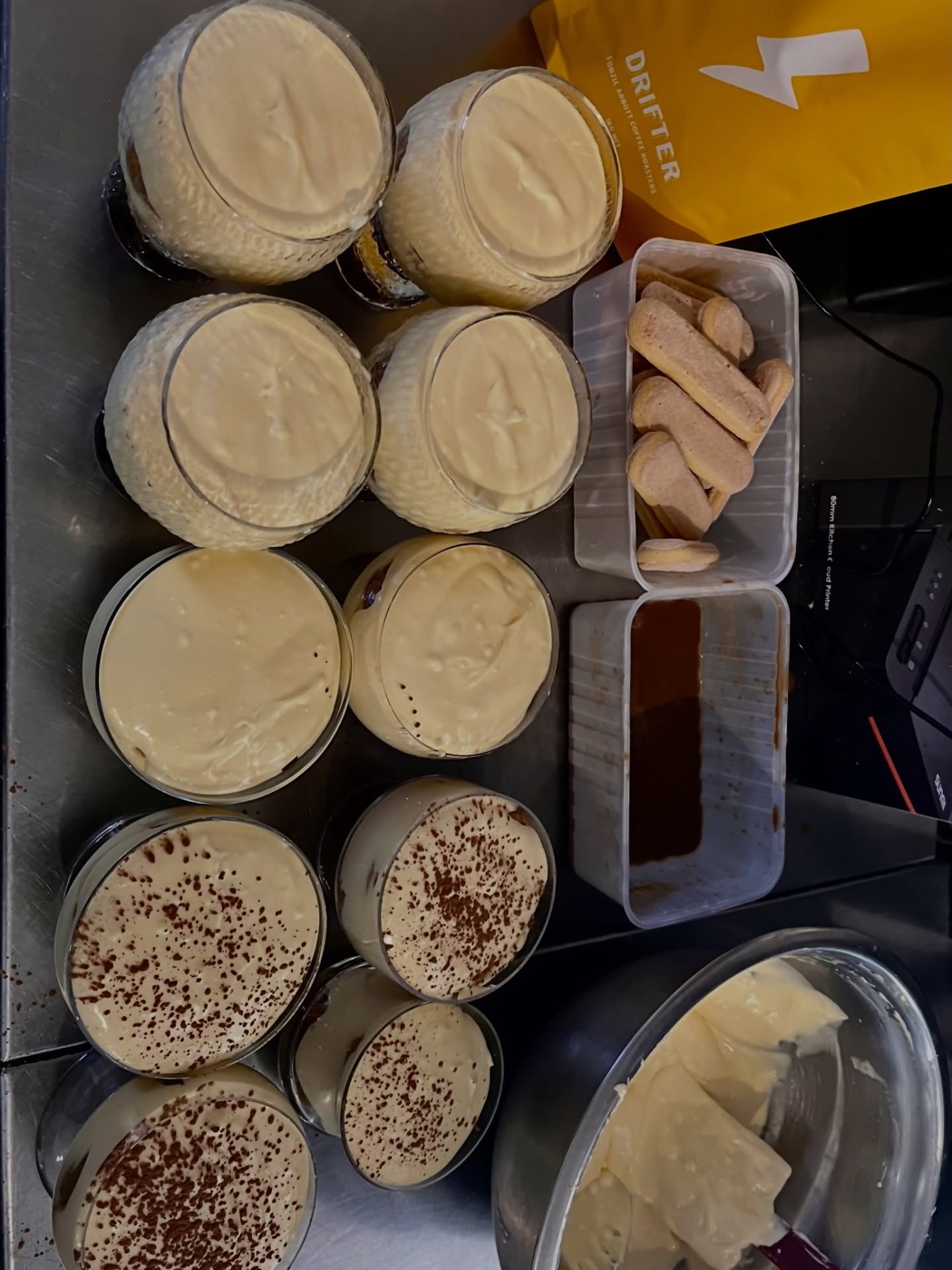 Tiramisu set out in glasses on the pass